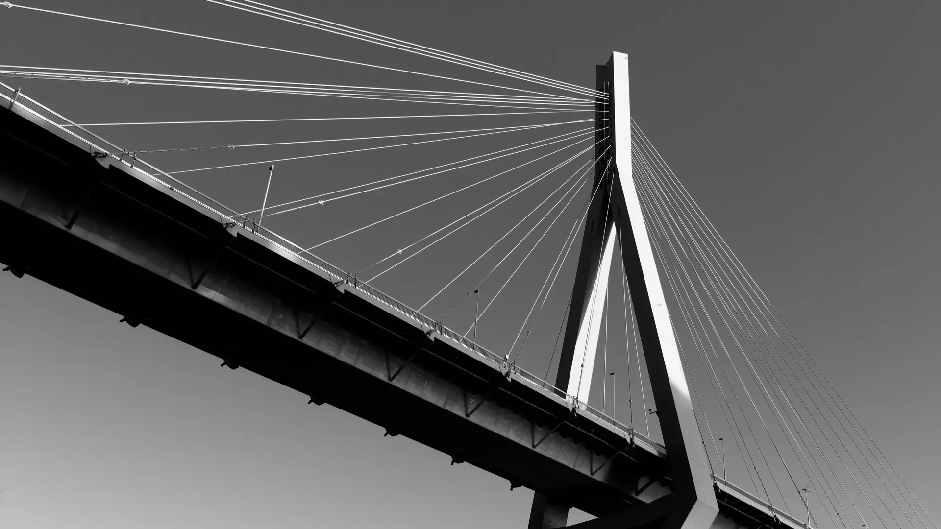 Cable-stayed bridge seen from below against a clear sky